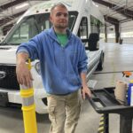 a man standing next to a white truck